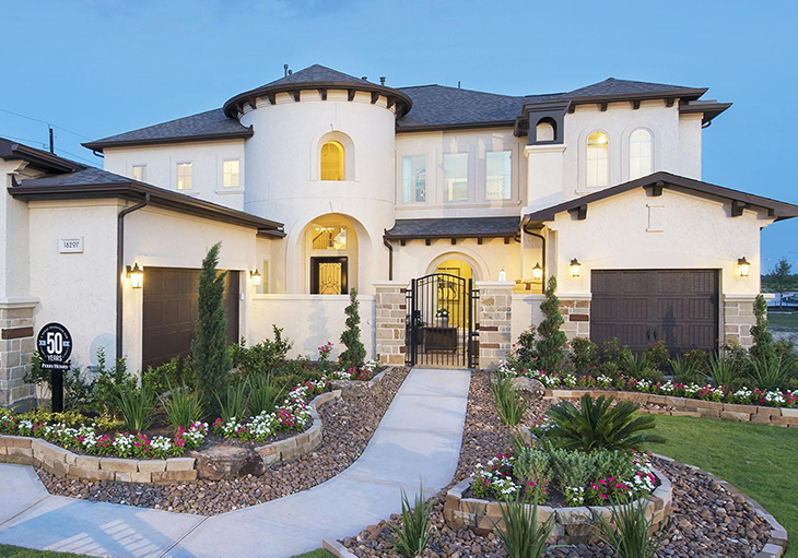 A beautiful two-story Perry Homes model house that
features a gated front entry and lush green landscaping