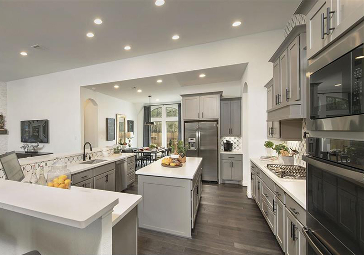 Perry Homes’ Design 3578W features white quartz countertops, grey cabinets and stainless-steel appliances